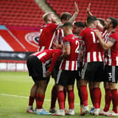 JOY: Sheffield United players celebrate Lys Mousset's vital second goal