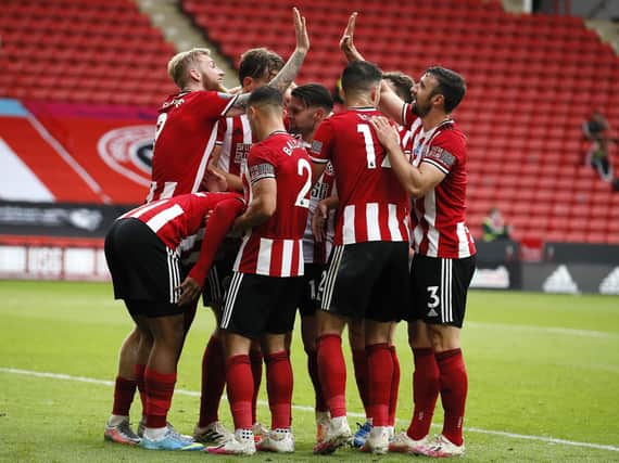 JOY: Sheffield United players celebrate Lys Mousset's vital second goal