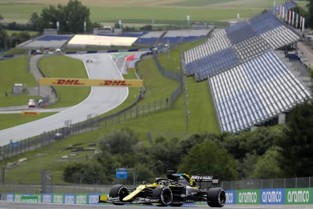 Renault driver Daniel Ricciardo of Australia steers his car in front of the empty stands. (AP Photo/Darko Bandic)