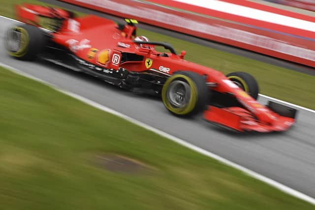 In this image taken with a slow shutter speed, Ferrari driver Charles Leclerc of Monaco steers his car during the first practice session at the Red Bull Ring racetrack in Spielberg, Austria, Friday, July 3, 2020.  (Joe Klamar/Pool via AP)