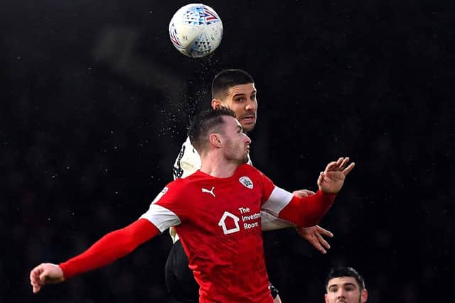 Influential: Barnsley’s Michael Sollbauer, pictured against Fulham’s Aleksandar Mitrovic, has helped shore up the previously pourous Reds defence. (Picture: PA)