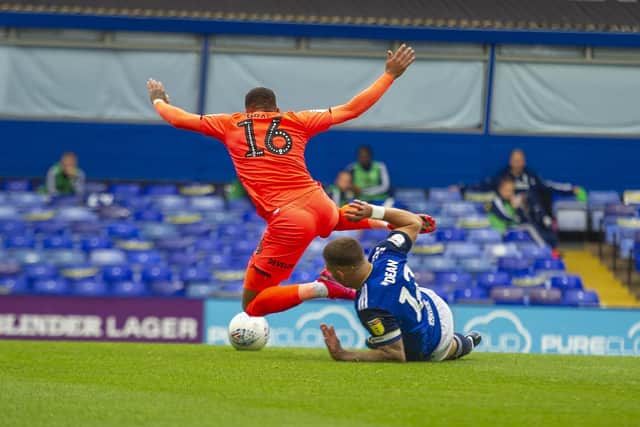 Blues captain Harlee Dean fouls Terriers' Karlan Grant to concede a penalty on Wednesday. (Picture:: Tony Johnson)