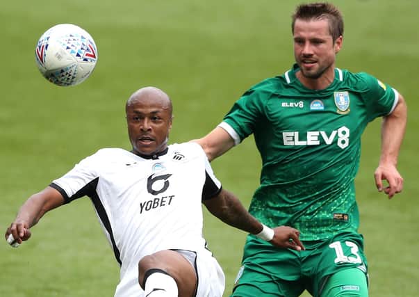 Swansea City's Andre Ayew (left) and Sheffield Wednesday's Julian Borner battle for the ball (Picture: PA)