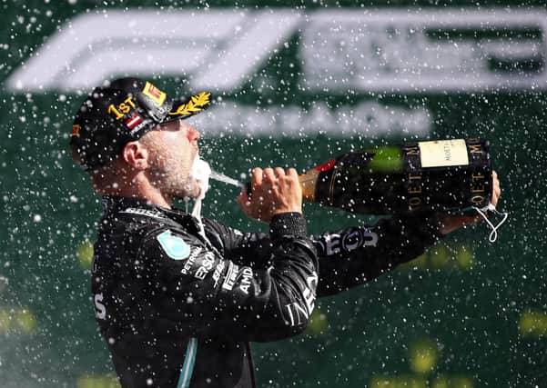 Mercedes driver Valtteri Bottas of Finland sprays champagne after winning the Austrian Formula One Grand Prix at the Red Bull Ring racetrack in Spielberg, Austria, Sunday, July 5, 2020. (Mark Thompson/Pool via AP)
