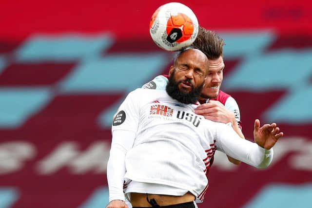 Sheffield United's David McGoldrick (front) and Burnley's Kevin Long battle for the ball.