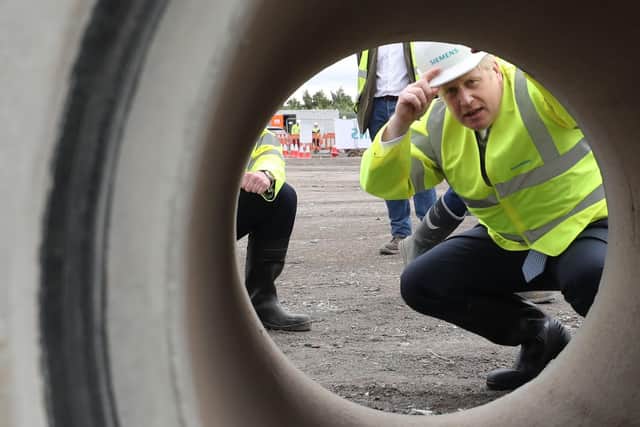 How will Boris Johnson fill the economic black hole? He's pictured making a factory visit to Goole.