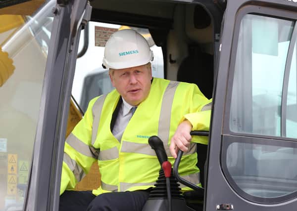 Prime Minister Boris Johnson in the cab of a digger during a visit to the Siemens Rail factory construction site in Goole.