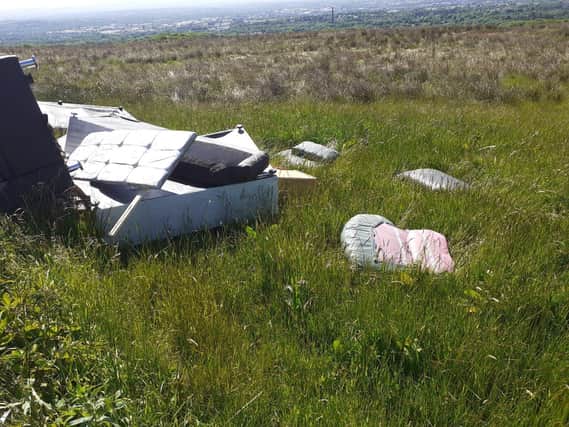 A flytipped bed on a Woodland Trust site in Bolton