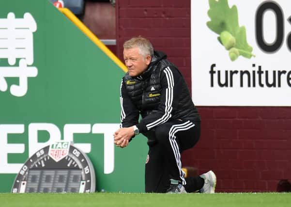 Sheffield United manager Chris Wilder takes a knee in support of the Black Lives Matter movement during the Premier League match at Turf Moor at the weekend Picture: Peter Powell/NMC Pool/PA