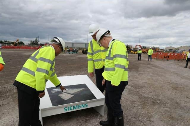 Prime Minister Boris Johnson (right) is shown a site drawing during a visit to the Siemens Rail factory construction site in Goole. Picture: Peter Byrne/PA Wire