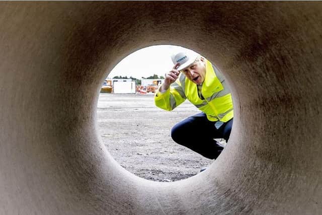 Prime Minister Boris Johnson looks through a large bore pipe during a visit to the Siemens Rail factory construction site in Goole. Picture: Peter Byrne/PA Wire