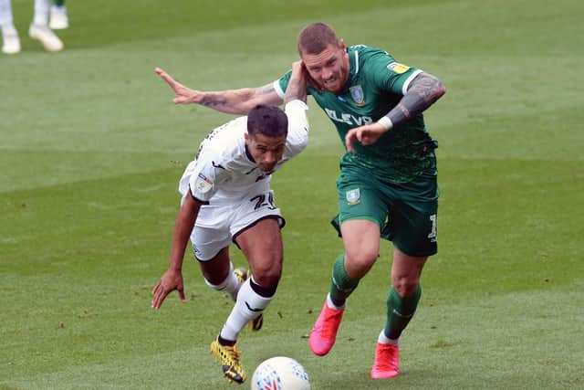 Sheffield Wednesday's Connor Wickham battles with Swansea City's Kyle Naughton. Picture: Steve Ellis