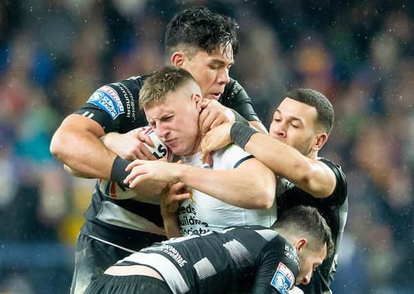 CONVINCE ME: Leeds Rhinos' Alex Mellor is tackled by Hull FC's Andre Savelio & Carlos Tuimavave. Picture by Allan McKenzie/SWpix.com