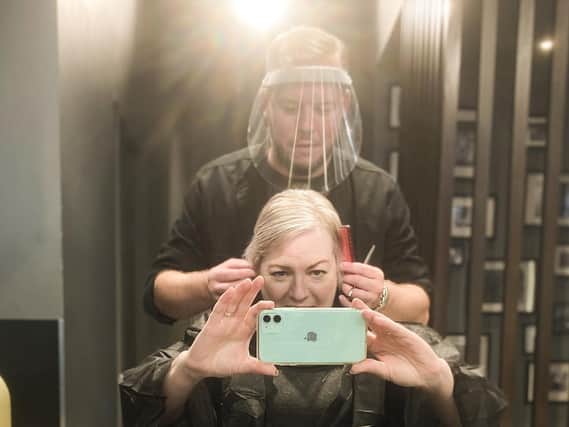 The first weekend back in business for hair salons and British Hairdresser of the Year Robert Eaton cuts Stephanie Smith's hair.