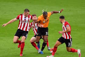 Sheffield United defenders crowd out Wolves danger man Adama Traore. PHOTO: PA.