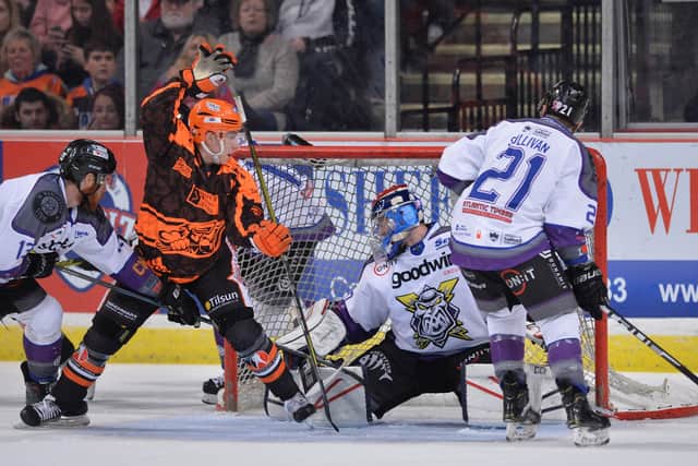 IN THE THICK OF IT: Kieran Brown squeezes home the puck for Sheffield Steelers in the Challenge Cup against Manchester Storm last season. Picture courtesy of Dean Woolley.