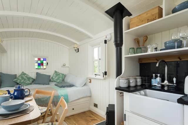 Inside the shepherd's hut - a king-size bed, mini kitchen and dining table plus a shower room