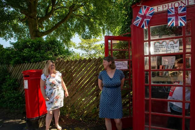 Martha Kennerley, 10, and her mother Jane, and Holly Jones in the phone box in St Hildas Road, Harrogate. Picture Bruce Rollinson