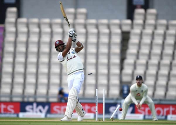 West Indies Shannon Gabriel is bowled out by England's Mark Wood.