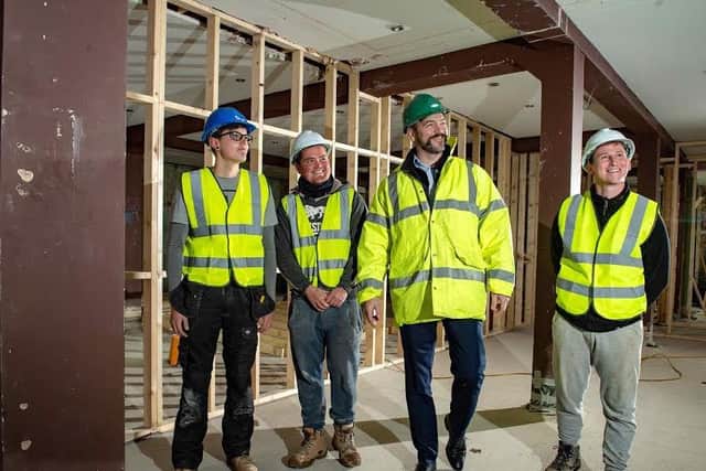Ian Anfield, managing director, with Hudson Contract-sponsored apprentices at a site in Bridlington