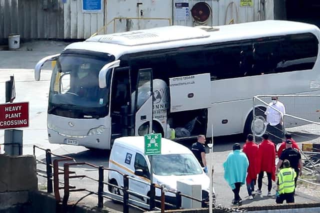 Border Force officers escort men thought to be migrants to a waiting bus in Dover, Kent, after small boat incidents in The Channel earlier this morning. Home Secretary, Priti Patel, is set to unveil details of how the UK's points-based immigration system - which will come into effect on January 1 after freedom of movement ends - will operate.