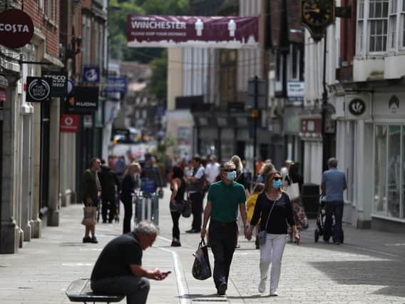 Library image of shoppers on a UK high street.  The retail sector is conducting a strategic reassessment of the needs of its store estate following the COVID-19 lockdown, according to KPMG.