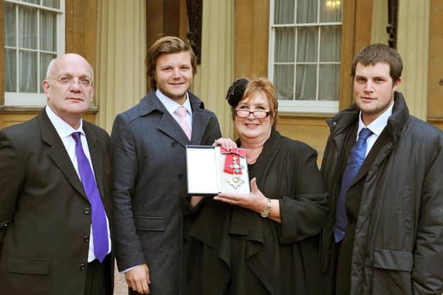 Dame Jenni Murray with (from left) husband David and sons Charlie and Ed in 2011 after she was made a Dame Commander by the Queen.Photo: John Stillwell/PA