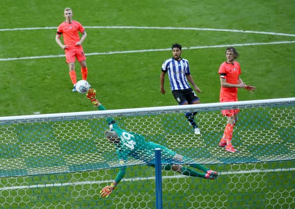 Huddersfield Town goalkeeper Jonas Lossl saves a shot from Sheffield Wednesday's Kadeem Harris (not in picture). Picture: PA