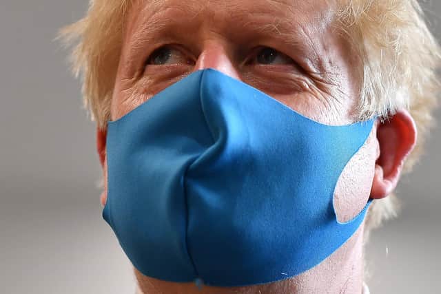 Boris Johnson says face coverings and masks will be mandatory in supermarkets and shops from next week.
