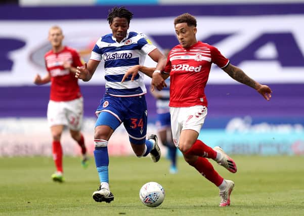 Reading's Gabriel Osho (left) and Middlesbrough's Marcus Tavernier battle for the ball . Picture: PA