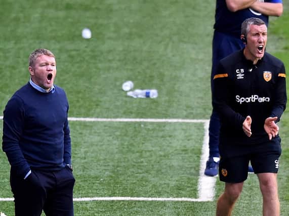Hull City head coach Grant McCann, left, and his assistant, Cliff Byrne, show their frustration from the sidelines during the Tigers' 8-0 mauling at Wigan Athletic. Picture: Getty Images