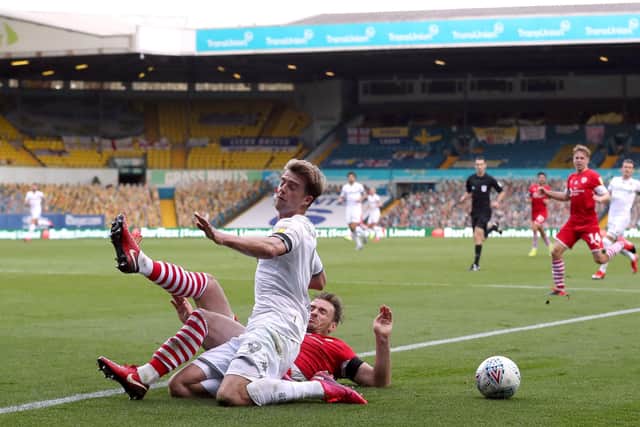 Leeds United's Patrick Bamford goes down under a tackle from Barnsley's Michael Sollbauer (Picture: PA)