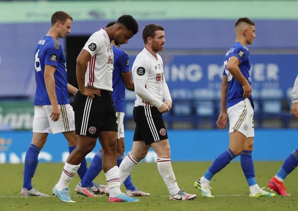 Disappointed Sheffield United duo Lys Mousset and John Fleck walk off the pitch. Picture: Darren Staples/Sportimage