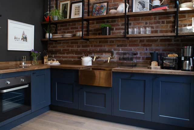 The kitchen is from Howarth Timber topped with a thick oak worktop with an inset copper sink