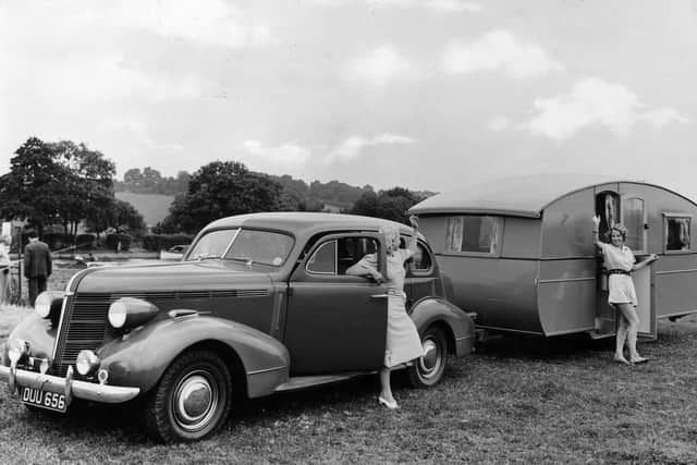 August 1939:  Two women wave to each other after arriving on holiday with their caravan.  (Photo by Fox Photos/Getty Images)