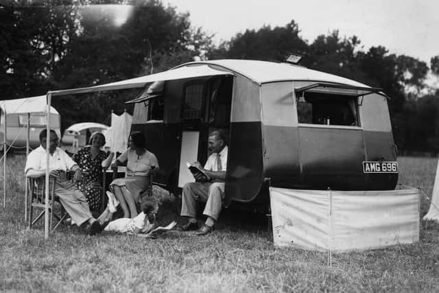 14th July 1934:  A family of campers relax outside their caravan at a gathering of the Camping Club of Great Britain and Ireland, held at Hurley Farm, Berkshire.  (Photo by J. A. Hampton/Topical Press Agency/Getty Images)