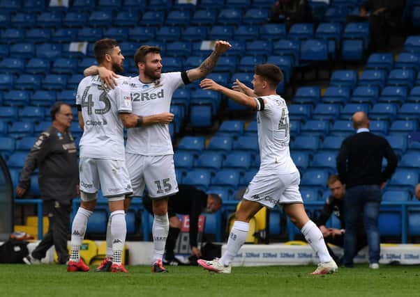Leeds United's Stuart Dallas and Mateusz Klich celebrate with Jamie Shackleton at full time against Barnsley. Picture by Jonathan Gawthorpe