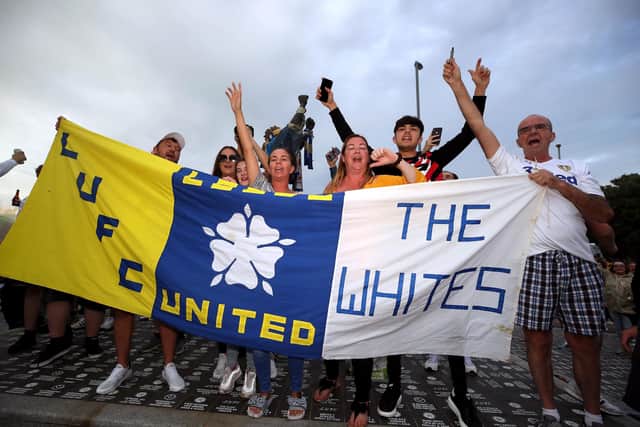 Leeds United fans celebrate outside Elland Road after Huddersfield Town beat West Bromwich Albion to seal their promotion to the Premier League. Picture: Nick Potts/PA