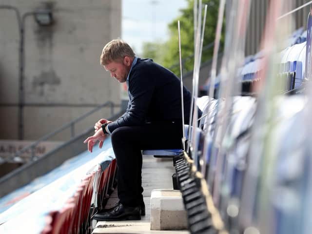 BEATEN: Hull City coach Grant McCann looks at his watch during Wigan Athletic's 8-0 win