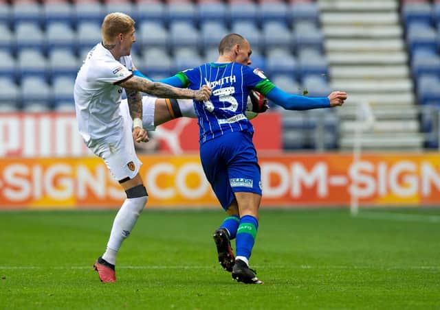 SORRY: Hull City's Jordy de Wijs puts Wigan's Kai Naismith under pressure at the DW Stadium.  Picture: Bruce Rollinson