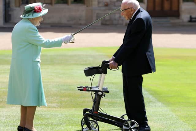 An official photo of the Queen knighting Captain Sir Tom Moore at Windsor Castle.