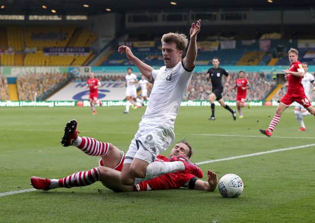 Leeds United's Patrick Bamford goes down under a tackle from Barnsley's Michael Sollbauer at Elland Road on Thursday. Picture: Martin Rickett/PA
