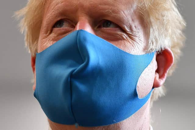 Boris Johnson wears a face mask - they will be mandatory in shops from this weekend.
