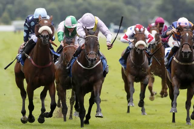 Moss Gill ridden by Daniel Tudhope (centre) wins the John Smith's City Walls Stakes at York.