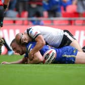 Top challenge: Hull FC's Danny Houghton's match-saving tackle on Warrington's Ben Currie. Picture: SWPIX