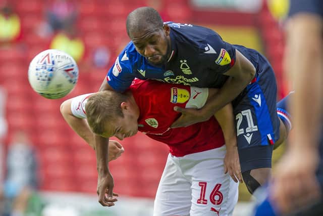 Luke Thomas gets the attentions of Forest's Samba Sow. (Picture: Tony Johnson)