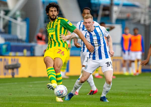 Ahmed Hegazi clears from Lewis O'Brien of Huddersfield Town (Picture: Bruce Rollinson)