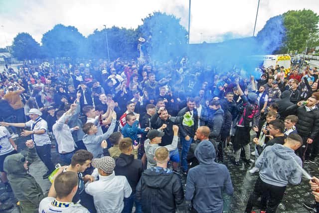18 July 2020 .....   Leeds United fans celebrate outside Elland Road going up as Champions into the Premier League after other results went the Whites. Picture Tony Johnson