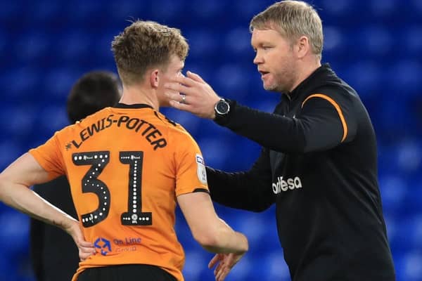 Hull City head coach Grant McCann consoles young forward Keane Lewis-Potter after the Tigers were relegated from the Championship following Wednesday's 3-0 defeat at Cardiff. Pictures: PA