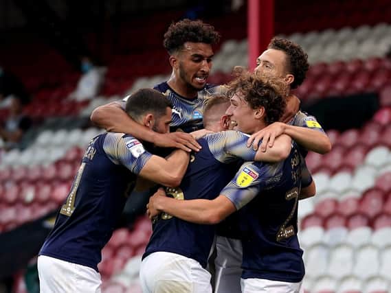 CRUCIAL: Callum Styles (right) celebrates scoring Barnsley's first goal at Brentford